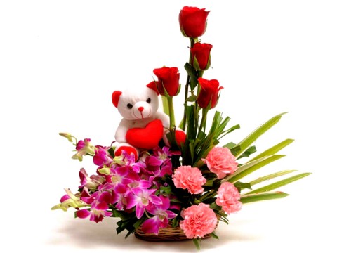 Teddies sitting in Basket with 18 pink carnations